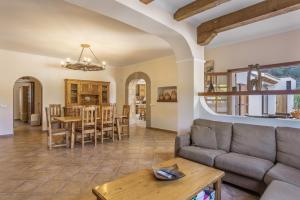 a living room with a couch and a table at Can Pepe Pujolet in Santa Gertrudis de Fruitera