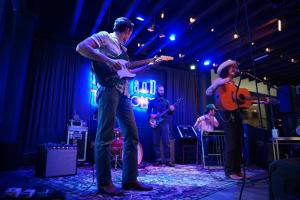 a group of people on a stage playing music at Haywood Park Hotel, an Ascend Collection Hotel in Asheville