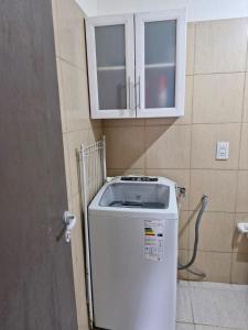 a washing machine in a bathroom with a cabinet at Casa centro in Tolhuin