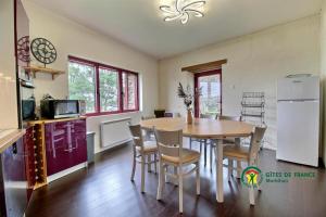 a kitchen and dining room with a table and chairs at Maison de la vilaine in Saint-Dolay