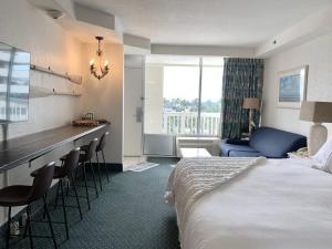 a hotel room with a bed and a table and chairs at Beach Access Elegant Studio near Top Attractions in Daytona Beach
