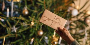 列维斯康塔体拉普兰酒店的一个人在圣诞树前举着礼物。 更多59张照片