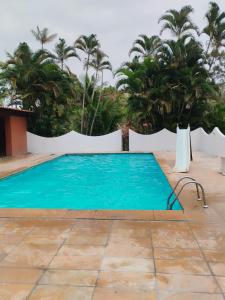 una piscina in un cortile con palme di Paradise a Saquarema