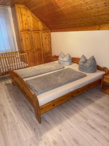 a large bed in a room with wooden ceilings at Márta Vendégház in Gyenesdiás