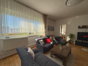 a living room with two couches and a table at Márta Vendégház in Gyenesdiás