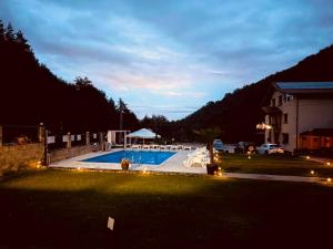 a view of a swimming pool at night at Casa Munty in Orlat