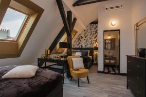 a bedroom with a bed and a desk and a sink at Golden Prague Rooms in Prague