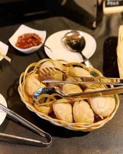 a basket of bread and spoons on a table at Aparthotel Green Concrete - Free Beach Bus in Świnoujście +141 photos