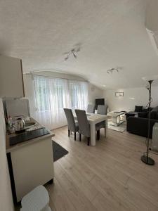 a kitchen and living room with a table and chairs at Villa Sale Buna in Mostar
