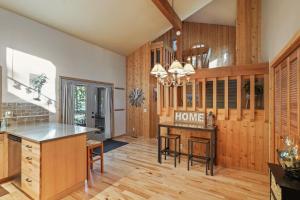 a kitchen with wood paneling and a home bar at 14 Mt Hood in Sunriver