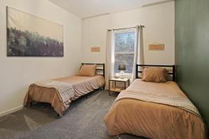 a bedroom with two beds and a window at Beaumont in Bend