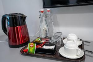 a tray with cups and bottles on a counter at Sunway Ukulhas in Ukulhas