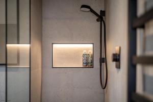 a shower in a bathroom with a picture on the wall at Caiplie Farmhouse, Caiplie, by Crail, KY10 3JR in Kilrenny +42 photos