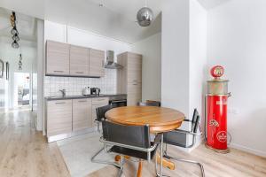 a kitchen with a wooden table and a red fire hydrant at Appartement de charme à Boulogne in Boulogne-Billancourt +7 photos