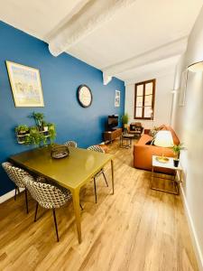 a living room with a table and a couch at Coeur Vieux Nice - Place Rossetti in Nice