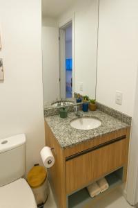 a bathroom with a sink and a toilet and a mirror at Liberdade SP a 250m do metrô in Sao Paulo +28 photos