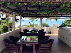 eine Terrasse mit Tisch und Stühlen und dem Meer in der Unterkunft Little Hill in Haad Rin