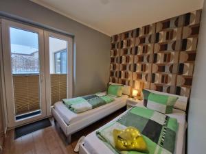 a small room with two beds and a window at Green Eagle Lodge in Lebbin