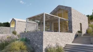 a house with a stone wall at Eks Mani Peninsula Retreat in Pírgos