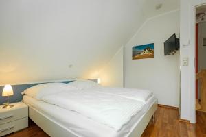 En eller flere senge i et værelse på Haus Pangea