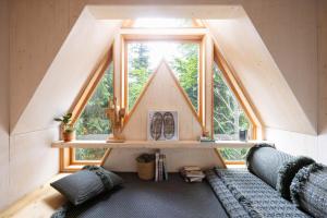 a room with two couches and a large window at Il Pino in Tarvisio