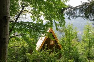 a cabin in the middle of a forest with trees at Il Pino in Tarvisio +8 photos