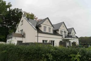 a large white house with black roof at Golf Oase in Lebbin