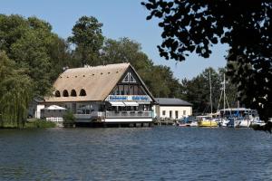 a large building sitting on top of a body of water at Am Hafen 15 in Röbel