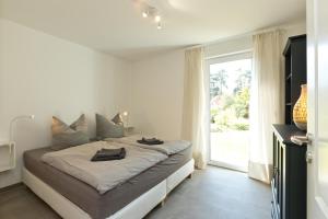 En eller flere senge i et værelse på Haus an der Sonne EG 107