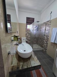 a bathroom with a sink and a shower at Villa Bloomscape in Galle +12 photos