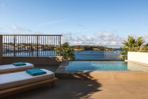 a swimming pool with a view of the ocean at Castello Infinity Suites - Adults Only in Agia Pelagia