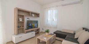 a living room with a couch and a table at Tia in Veli Lošinj