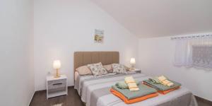 a bedroom with a bed with two pillows on it at Tia in Veli Lošinj