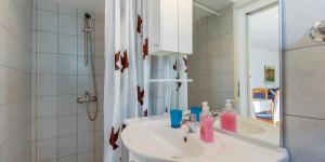 a white bathroom with a sink and a mirror at Tia in Veli Lošinj +54 photos