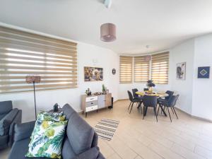 a living room with a couch and a table and chairs at Villa Allegra in Protaras