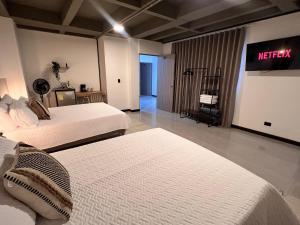 a hotel room with two beds and a sign on the wall at Hotel Moore 45 in Medellín