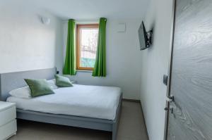 En eller flere senge i et værelse på Aosta Holiday Apartments - Charvensod