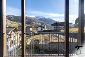 a view of a mountain from a balcony at HOTIDAY Bormio Apartments in Bormio