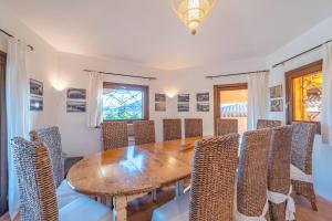 a dining room with a wooden table and chairs at Villa Il Varo - By Searly in Liscia di Vacca