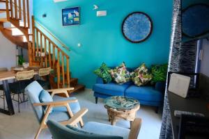 a living room with a blue couch and stairs at Casa Anthos free parking in Chania Town