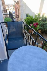a blue table and bench on a balcony at Casa Anthos free parking in Chania Town