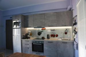 a kitchen with stainless steel cabinets and a refrigerator at Casa Anthos free parking in Chania Town +14 photos