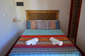 a bed with two pillows on top of it at Gosén Cabañas Sanagasta in Villa Bustos +20 photos