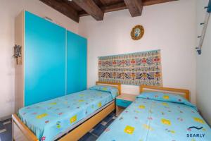 En eller flere senge i et værelse på Villetta Teodorina - By Searly