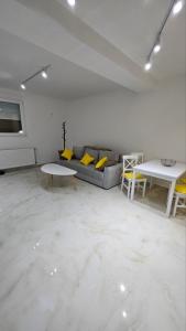 a living room with a couch and a table at Spring 4 in Petrovaradin