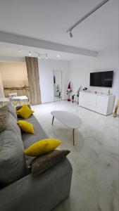 a living room with a gray couch with yellow pillows at Spring 4 in Petrovaradin