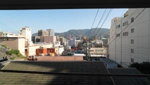 a view of a city from the roof of a building at 佐世保まち宿 in Sasebo