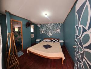 a bedroom with a bed in a room with blue walls at Gugma Tiu Homestay Port Barton in Manila