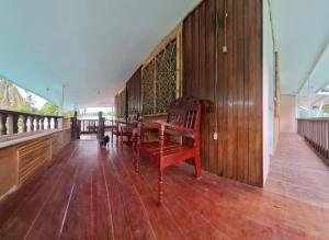 a wooden porch with a bench on a wooden floor at Gugma Tiu Homestay Port Barton in Manila