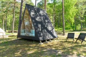 two chairs and a tent in a field at Forest View Cottage 